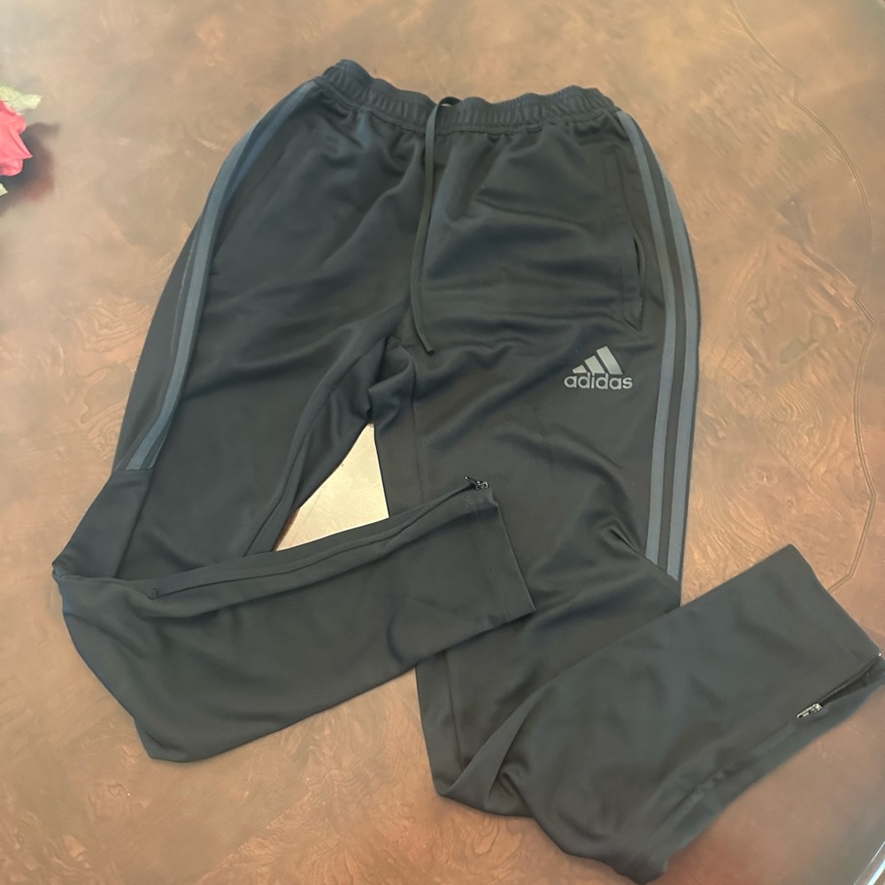 Adidas Pants in black with charcoal side stripes. Women’s size small.